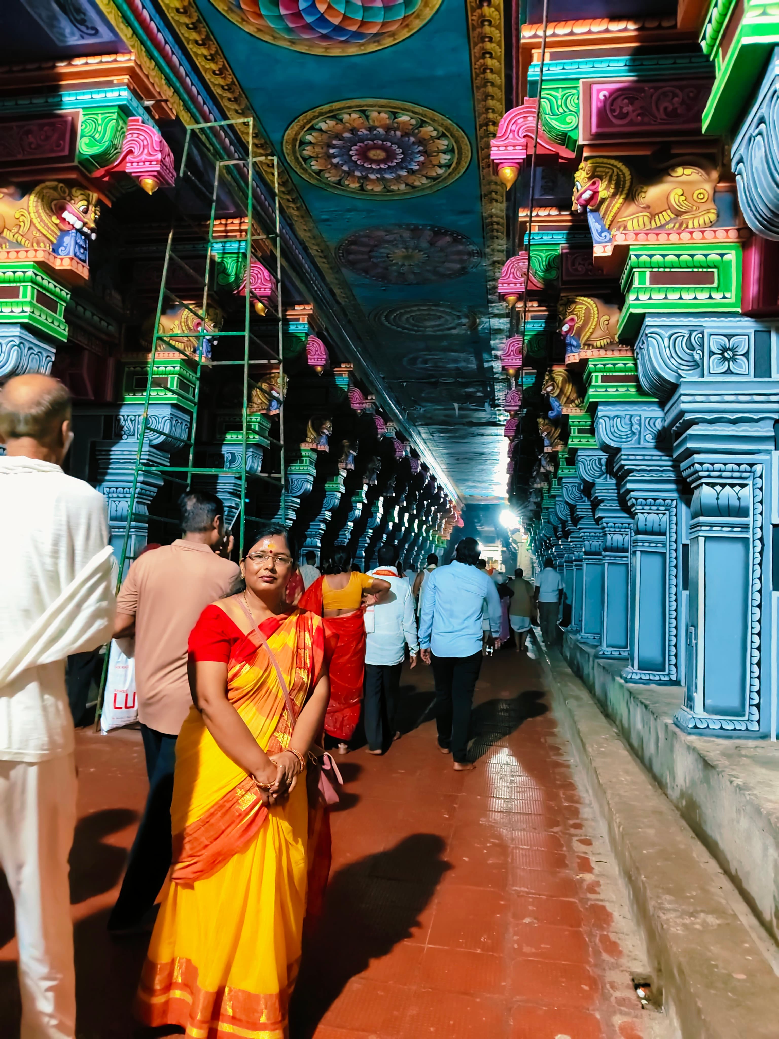 Sangeeta Kumari in a yellow saree in a South Indian temple corridor